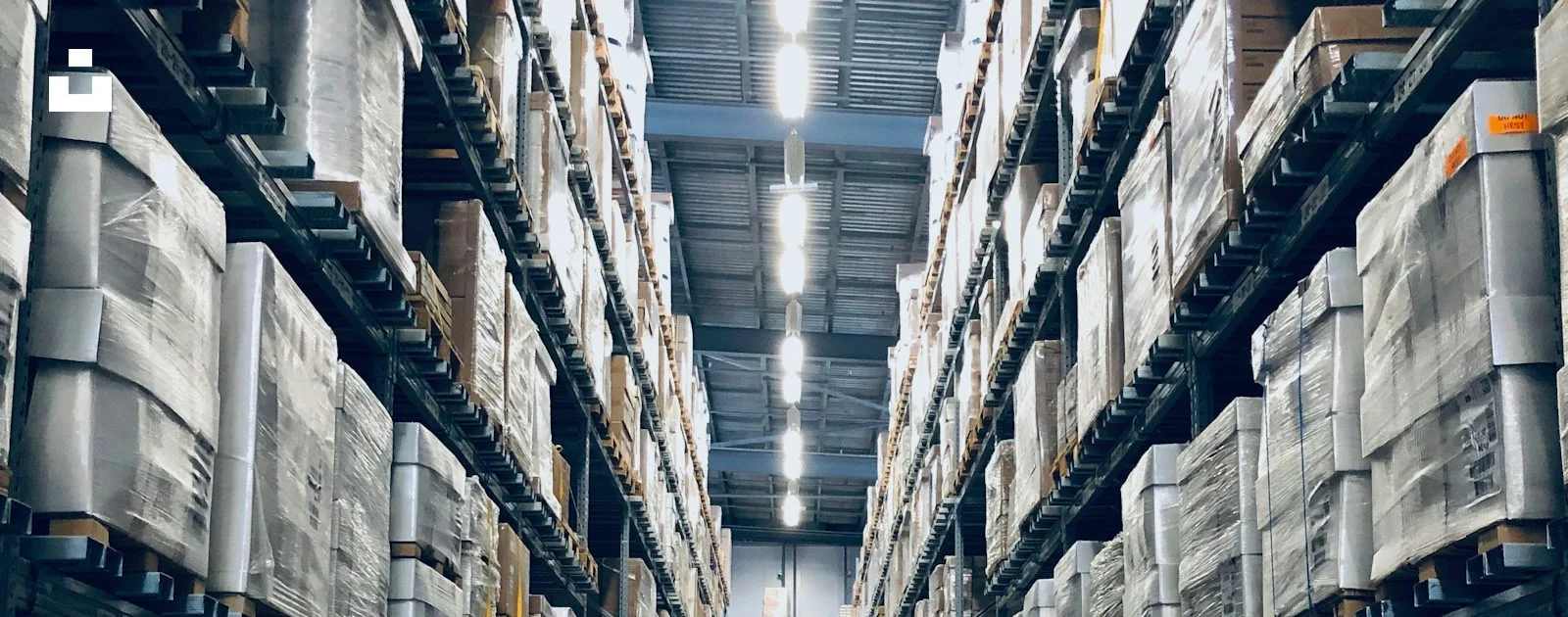 A warehouse interior with storage aisles and industrial roof structure