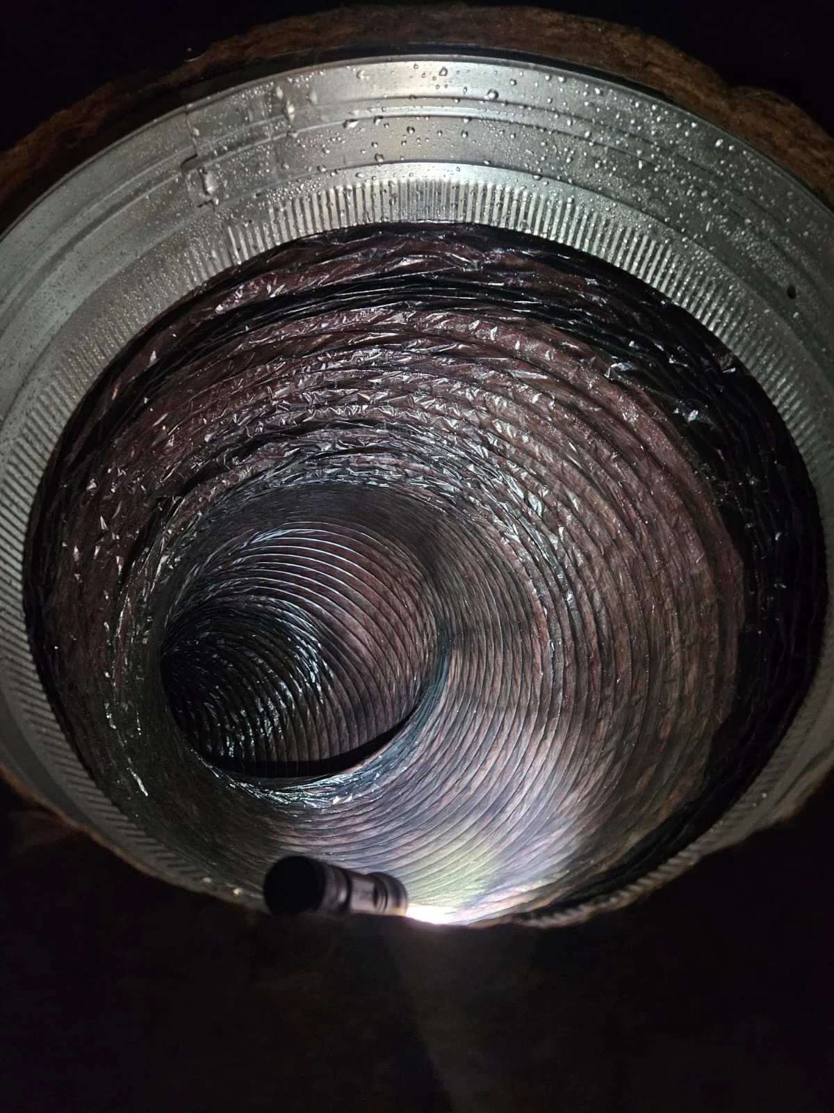 PAC archive photograph looking into ductwork with an inspection light