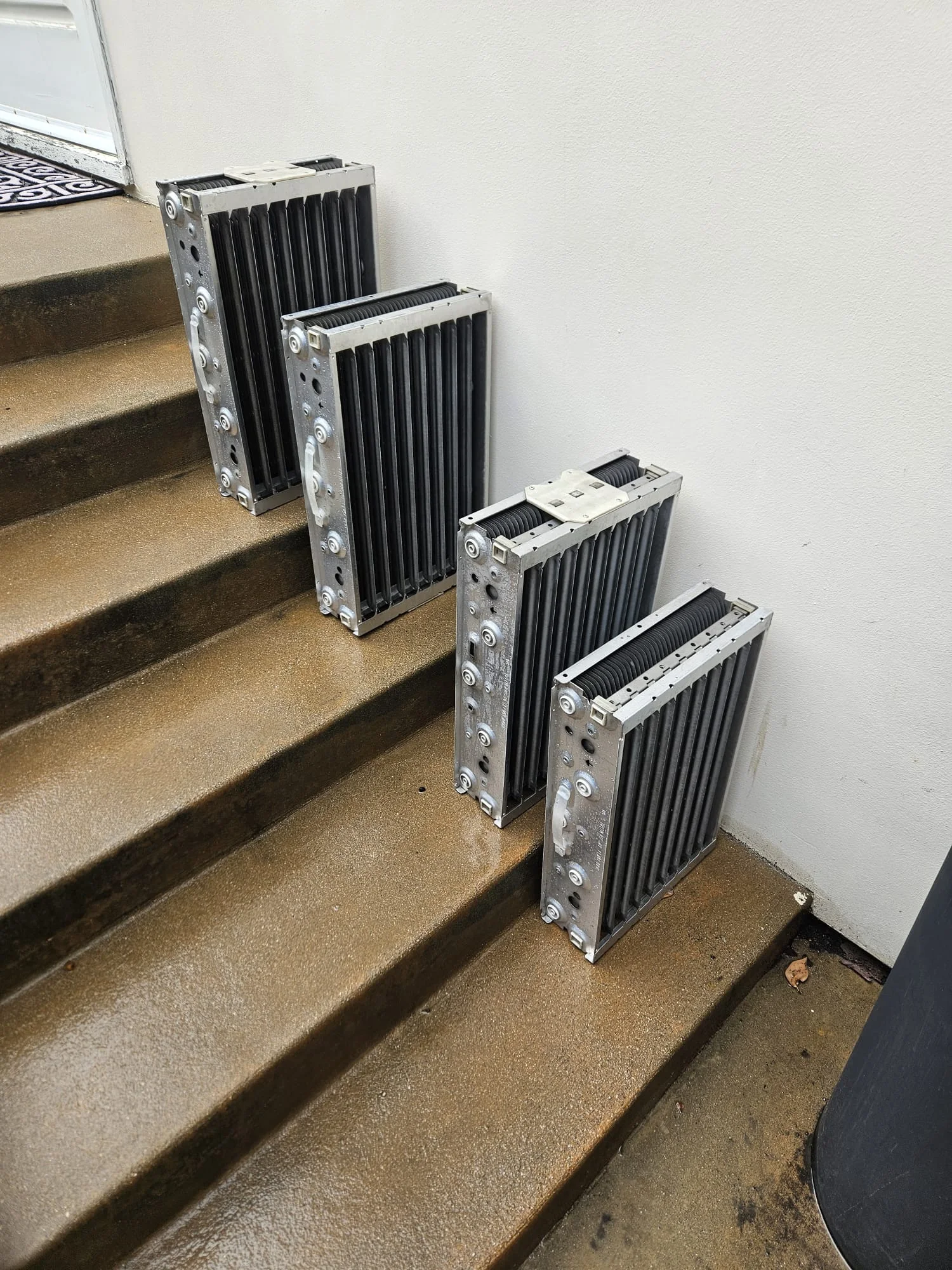 Metal electrostatic collector cells removed for servicing